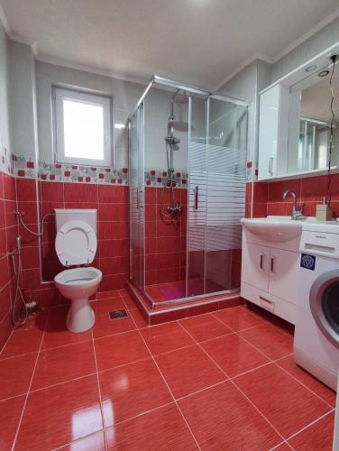 a bathroom with a toilet and a shower and a sink at Villa Green Oasis Swimming Pool in Sarajevo