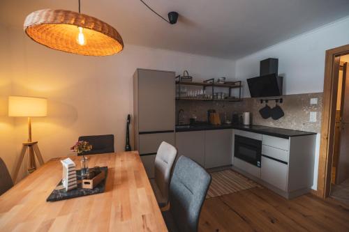 a kitchen and dining room with a table and chairs at Der Sagbauer in Donnersbachwald