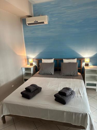 a bedroom with a bed with two pillows on it at Sea You - Apartments in Avlákia