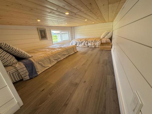 a bedroom with two beds and a wooden floor at Mountain View Retreat in Creston
