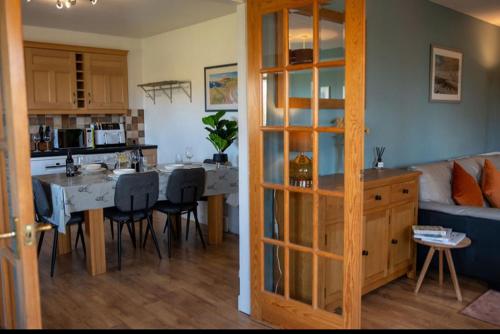 a kitchen and living room with a table and a couch at Inskeyft - Kirkwall in Kirkwall