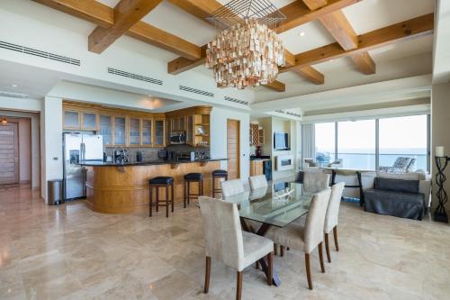 a dining room and kitchen with a table and chairs at Ocean Wrap Around Oceanfront Balcony at Tessoro in Las Conchas