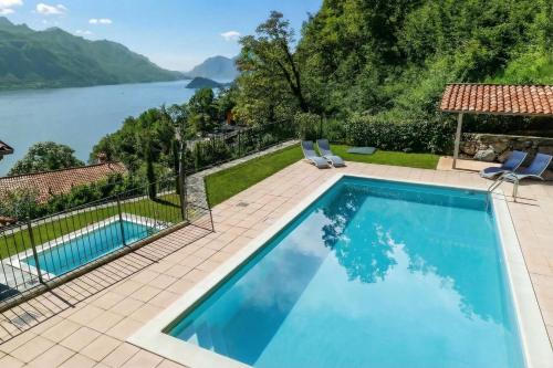 a swimming pool with a view of a lake at Le Petit Palais Villa in Plesio