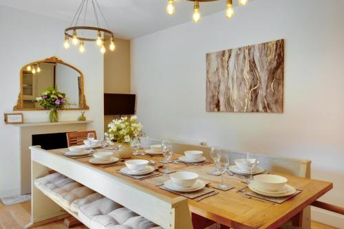 a dining room with a table with plates and glasses at 4 Bed in Broadstairs oc-w28331 in Broadstairs