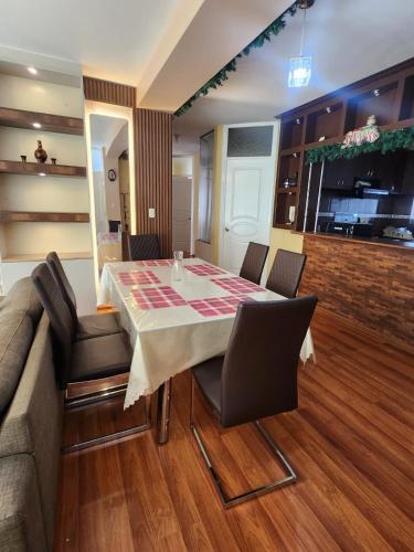 a dining room with a table and a couch at Refugio del Lago in Puno