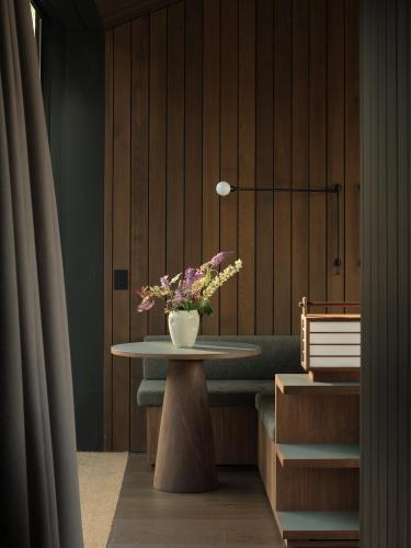 a table with a vase of flowers on top of it at Moke Valley Queenstown in Queenstown