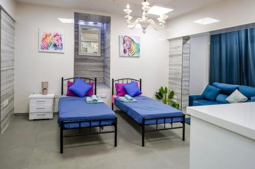 a living room with two beds and a couch at The Oyster - F in Il-Furjana