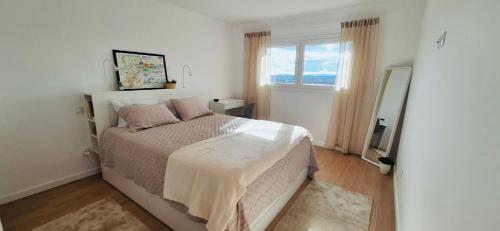 a bedroom with a bed and a window at Valença Sky View in Valença