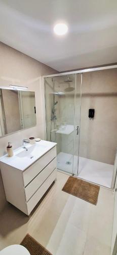a bathroom with a shower and a sink and a toilet at Valença Sky View in Valença