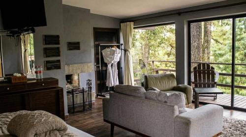 a living room with a couch and a chair and a window at Orgánico Hotel Boutique in Mexico City