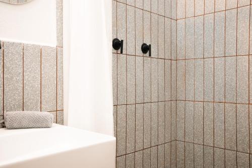 a bathroom with a shower and a white tub at Casa Serdán in Puebla