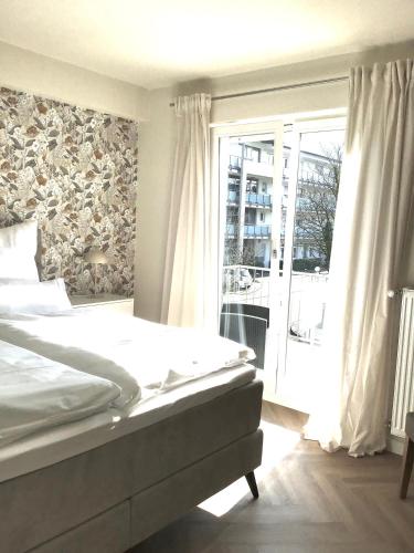 a bedroom with a bed and a large window at Fewo Anna in Bernkastel-Kues