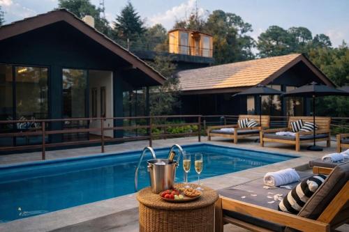 a pool with a table and glasses of wine at Orgánico Hotel Boutique in Mexico City
