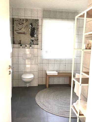a bathroom with a toilet and a window at Fewo Anna in Bernkastel-Kues