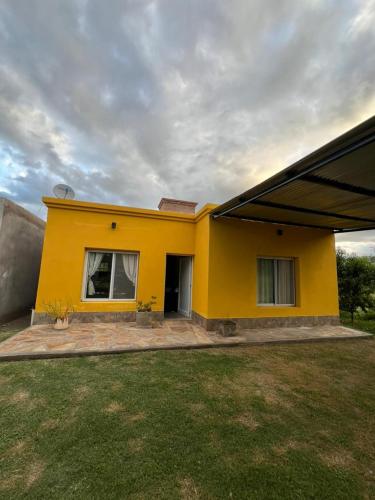 a yellow house with a yard in front of it at Casa en La Puntilla in Belén