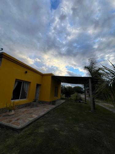 a large yellow house with a sky at Casa en La Puntilla in Belén