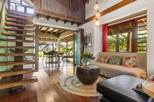 a living room with a couch and a table at Tropical 2BR Bungalow with Private Pool in Taravao