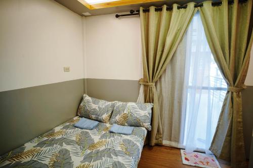 a couch in a room with a large window at Isla Enriqueta - Private Beach Resort in Iba