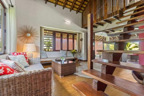 a living room with a couch and a table at Charming Tropical Retreat with Private Pool in Taravao