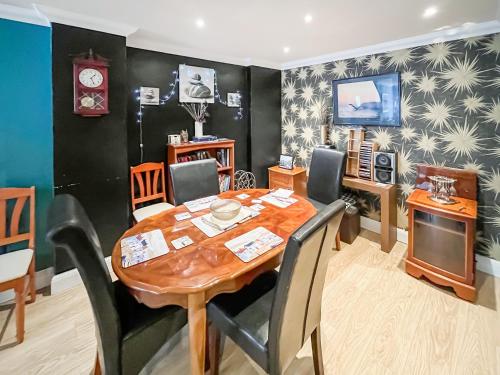 a dining room with a wooden table and chairs at Turner Villa in Ramsgate