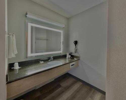 a bathroom with a sink and a mirror at Discovery Inn in Midvale