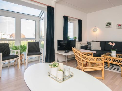 a living room with a couch and a table at 6 person holiday home on a holiday park in Hejls in Hejls