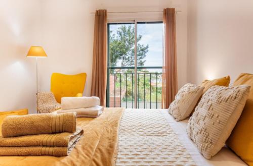 a bedroom with a large bed and a window at Casa Nobrega in Caniço