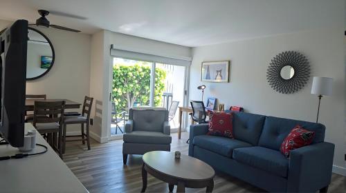 a living room with a blue couch and a table at Resort-Style Family Getaway in Santa Monica in Los Angeles