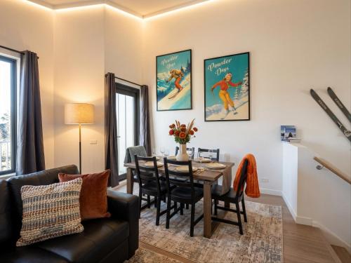 a living room with a table and a dining room at Mount Buller Alpine Chalet Mountain Views Sleeps up to 12 in Mount Buller