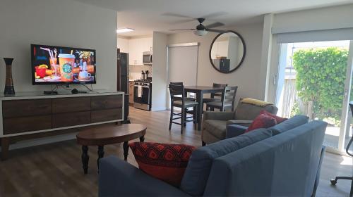 a living room with a couch and a dining room at West LA Boutique Apartments Minutes from the Coast in Los Angeles