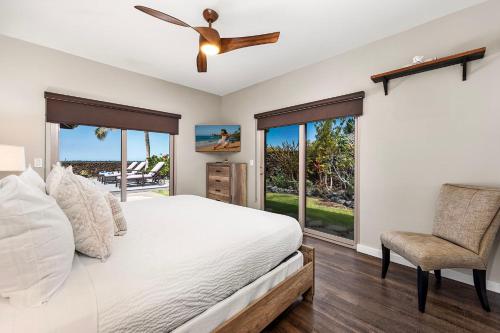 a bedroom with a bed and a ceiling fan at Ainamalu 9 in Waikoloa