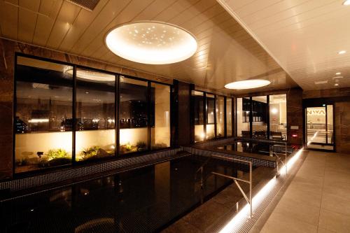 a lobby of a building with windows and lights at THE RISE Osaka Universal Bayside in Osaka
