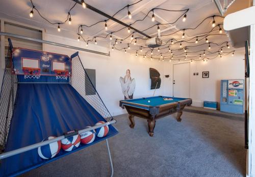 a room with a pool table and ping pong ball at Mid-Century Modern Home - Hot Tub and Game Room in Denver