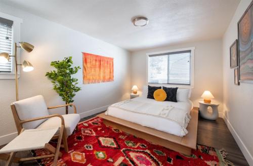 a bedroom with a bed and a red rug at Mid-Century Modern Home - Hot Tub and Game Room in Denver