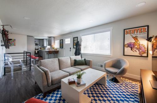 a living room with a couch and a table at Mid-Century Modern Home - Hot Tub and Game Room in Denver