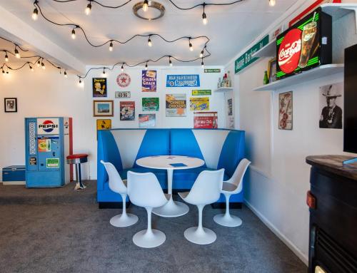 a restaurant with a blue table and white chairs at Mid-Century Modern Home - Hot Tub and Game Room in Denver