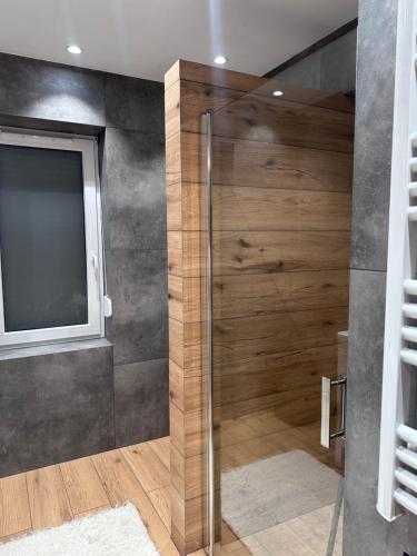a shower with a glass door in a bathroom at Dom pod Aniołem in Sierakowice Prawe