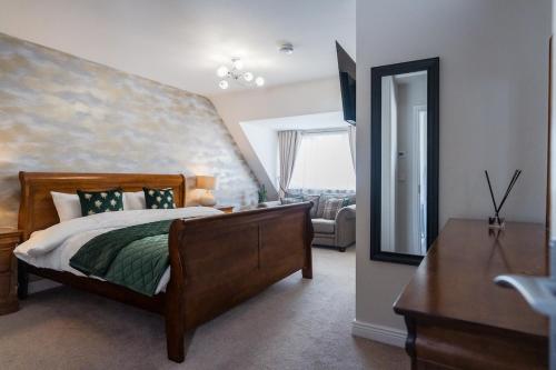 a bedroom with a bed and a dresser and a mirror at Dublin Premier Oasis in Ráth Cúil