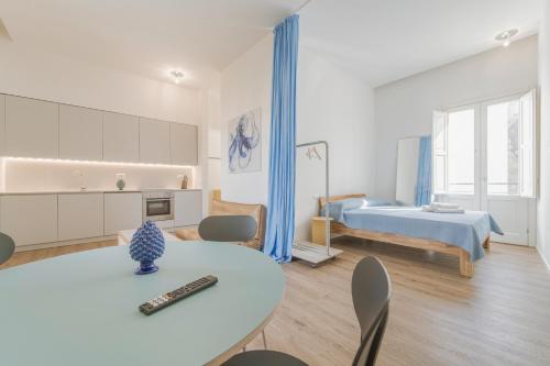 a living room with a bed and a table and chairs at Dimora del Polpo - Centro Storico in Trapani