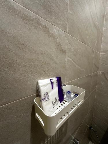 a bathroom with a towel holder on the wall at شقق وغرف الرصف in Hail