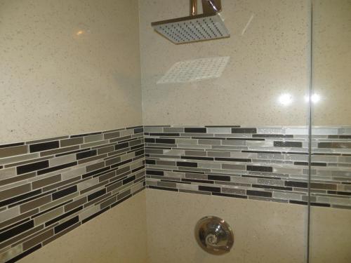 a bathroom with a shower with a glass door at Sterling Inn in Santa Clara
