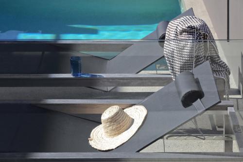 a straw hat sitting on top of a bench at Thirteen Bowman - Sunshine Beach, Ocean Views in Sunshine Beach