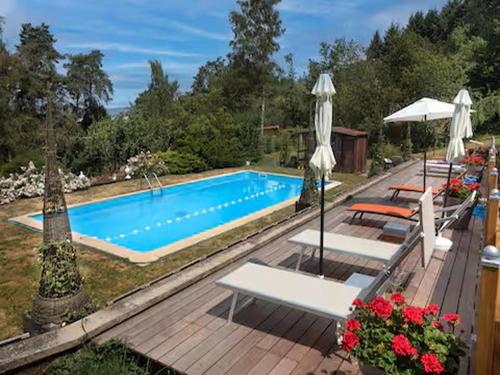 a swimming pool with two chairs and an umbrella at Cosy Castle with Pool in Onlay in Onlay