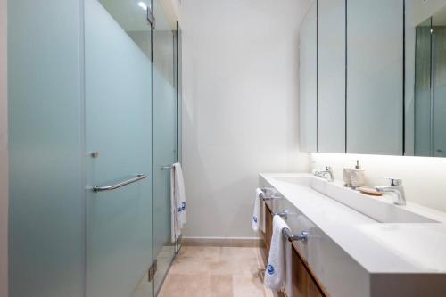 a bathroom with a sink and a shower and a mirror at Zantamar TH06B, oceanfront in Cruz de Huanacaxtle