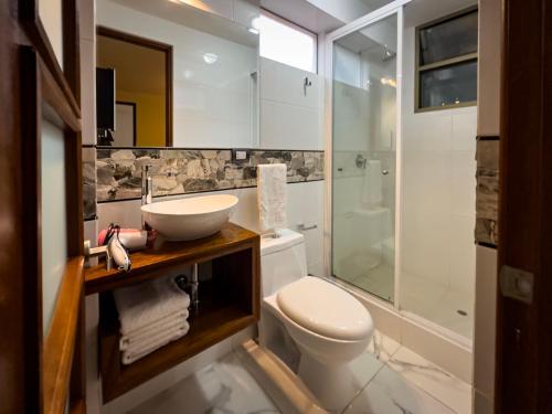 a bathroom with a toilet and a sink and a shower at La Posada de Francisca in Pisac