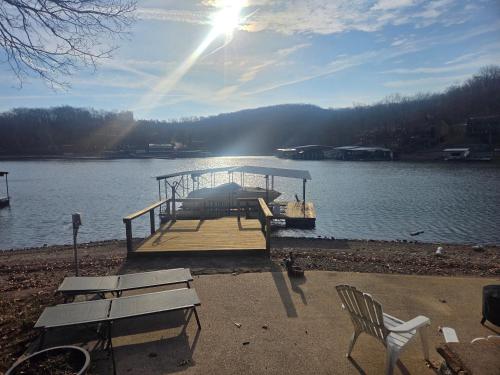 a dock in the middle of a lake at Shady Valley Lakefront Cottage in Sunrise Beach