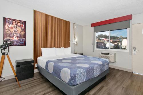 a bedroom with a bed and a large window at Royal Pagoda Motel Dodger Stadium in Los Angeles