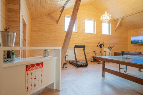 a gym with a coca cola table and treadmill at Hof Friesenruhe in Högel
