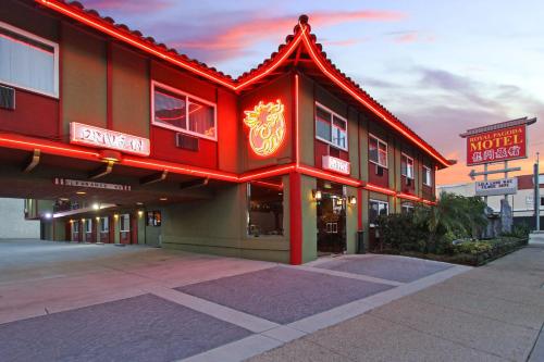 a red building with a sign on the side of it at Royal Pagoda Motel Dodger Stadium in Los Angeles