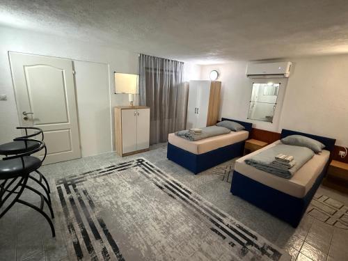 a hotel room with two beds and a mirror at Apart Cobras Jajce in Jajce